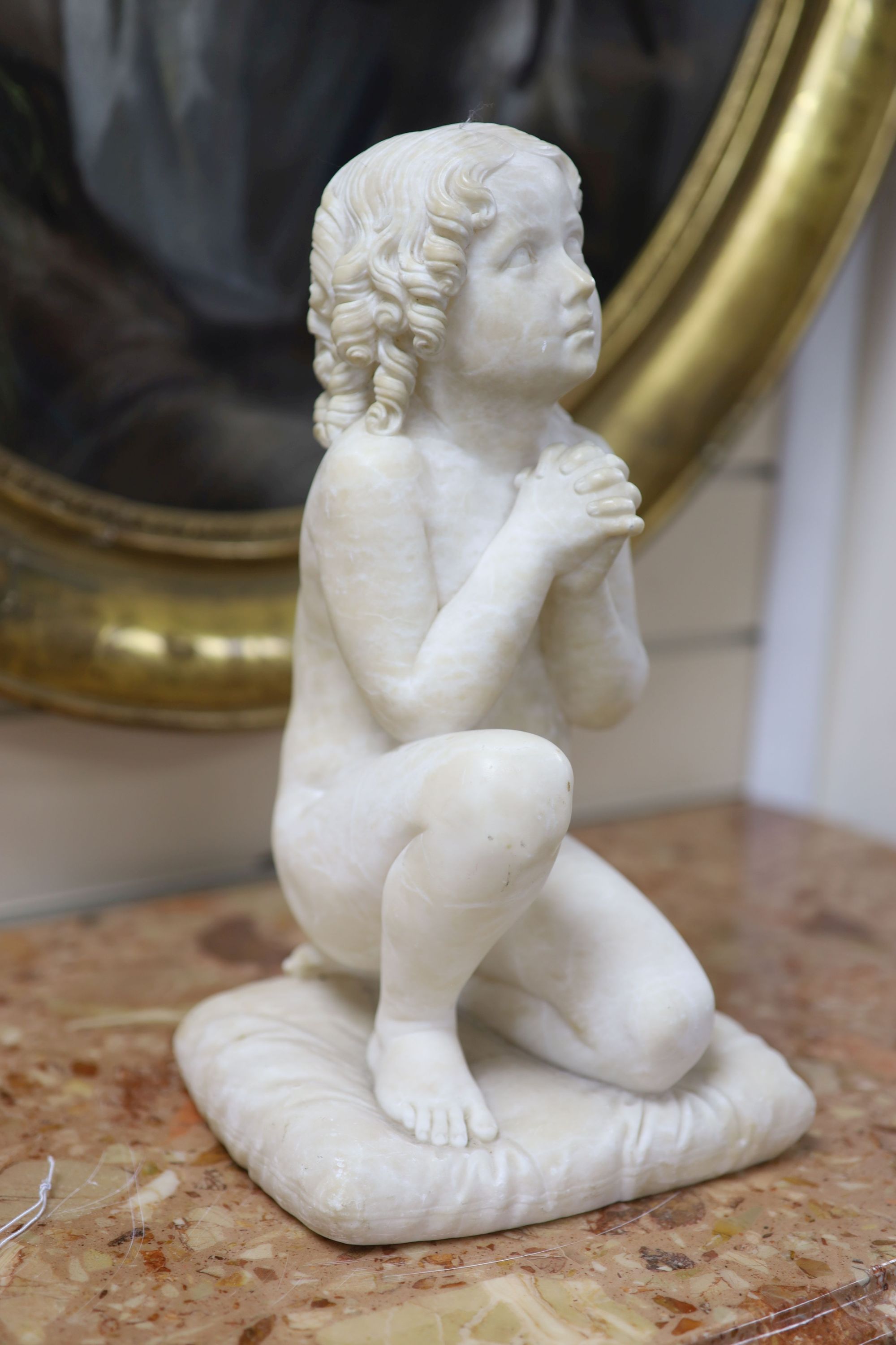 Italian School c.1900. An alabaster carving of a praying child, height 34cm (repaired)